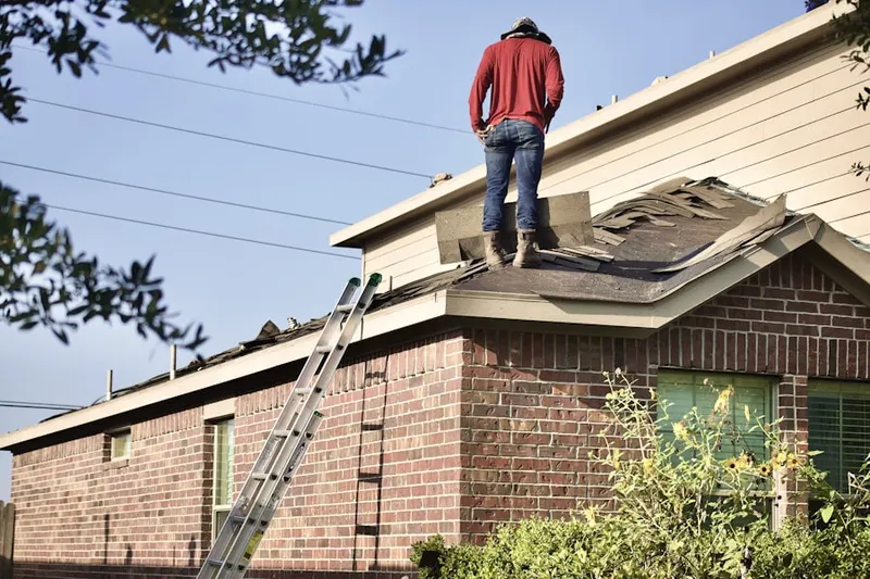 Professional roofer working on a residential roof in Crestview Hills